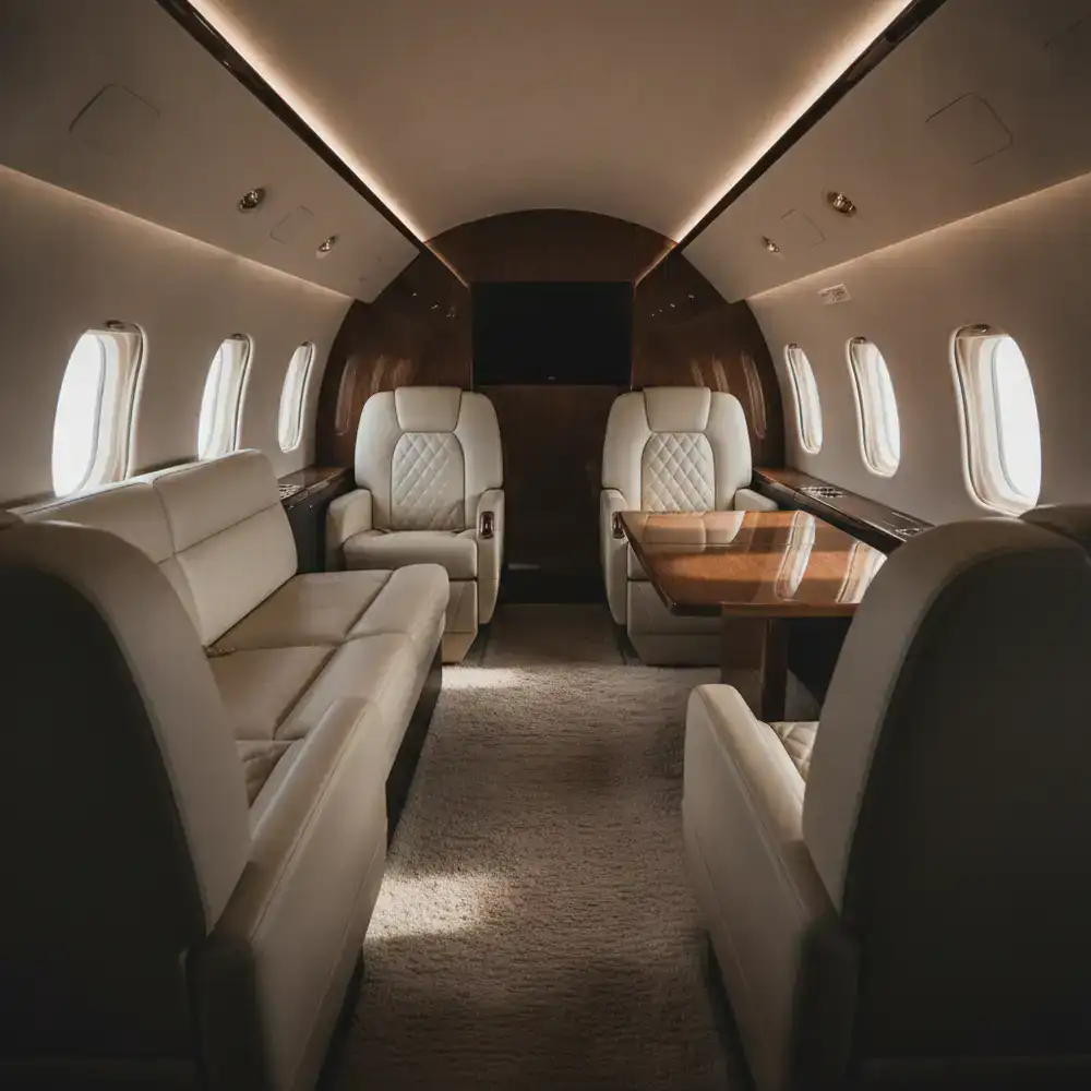 Luxurious and bright interior of a midsize private jet with leather seating